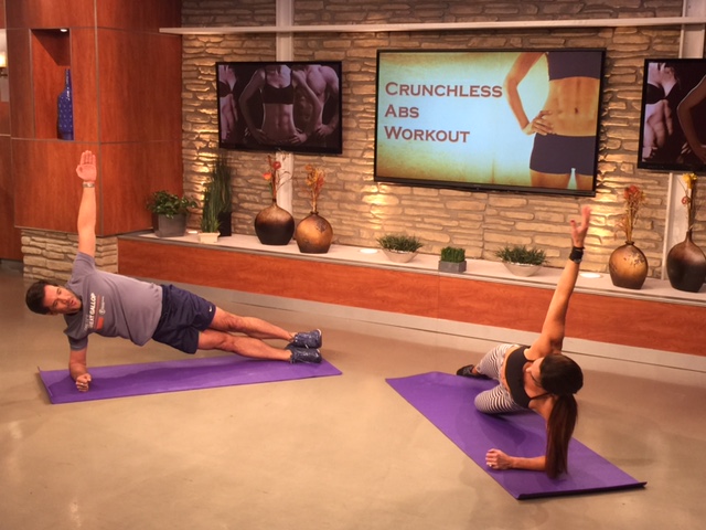 JD Roberto and Natalie Jill in a side plank 